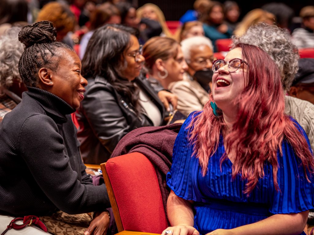 Student and alumna laughing in Kasser Theater