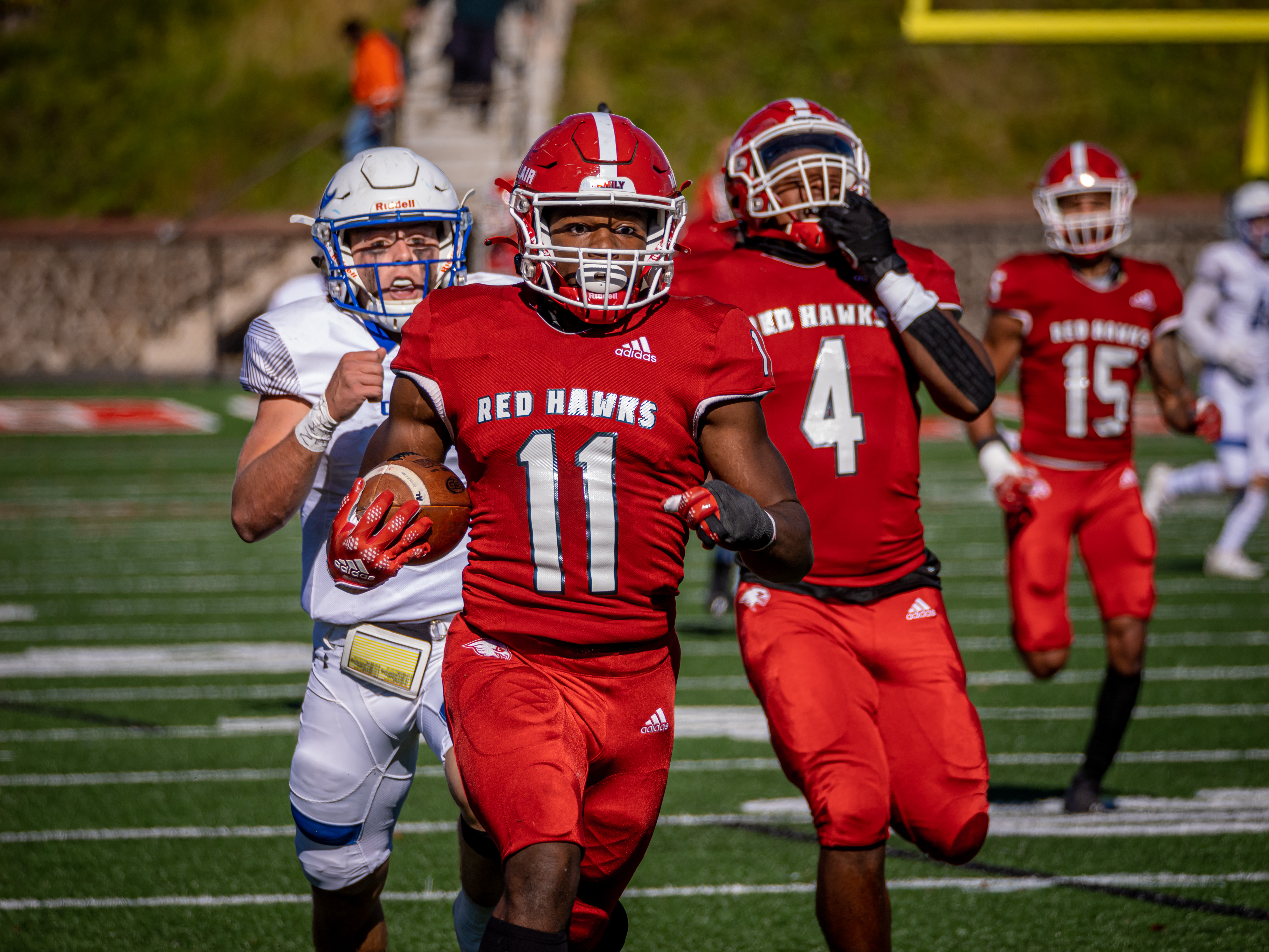 Montclair football player running with ball