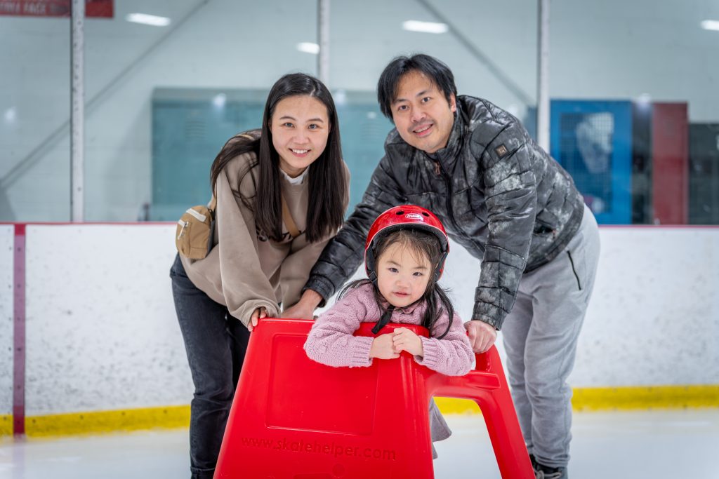 Couple ice skating with child