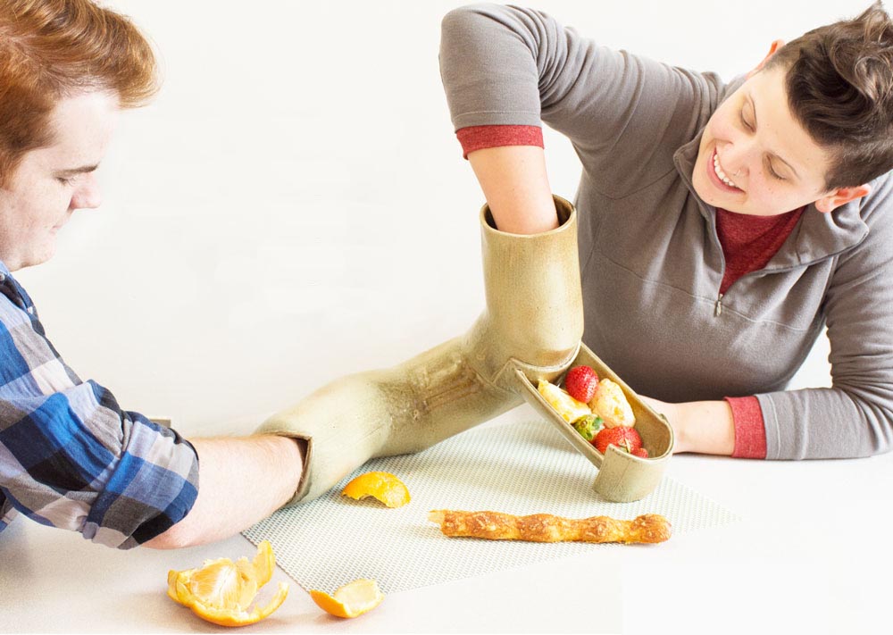 2 People playing with ceramic tube and food