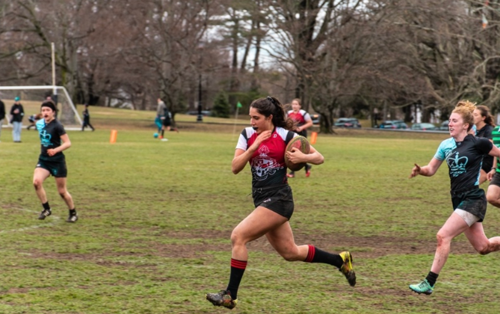 Montclair State University club women's rugby player running down the field