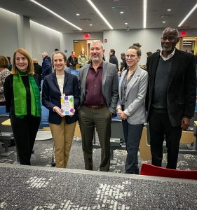 People standing and smiling in a line.