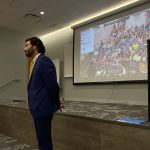 President Johnathan Koppell standing in front of projector showing the zoom audience.