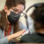 Cindy Fernandez tests a student’s hearing.