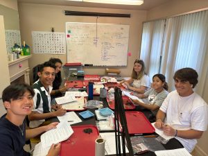 group of students smiling at lab table