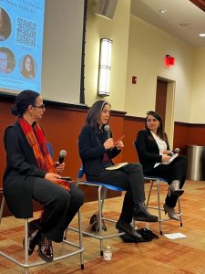 panelists sitting on chairs and speaking during event
