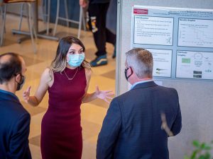 Melissa Spigelman explaining her research during the poster session