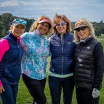 Four women standing on golf course