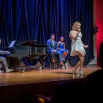 Student sings on stage.