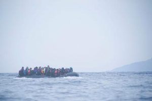 An image of refugees on a boat crossing the Mediterranean