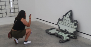 woman taking picture of maps