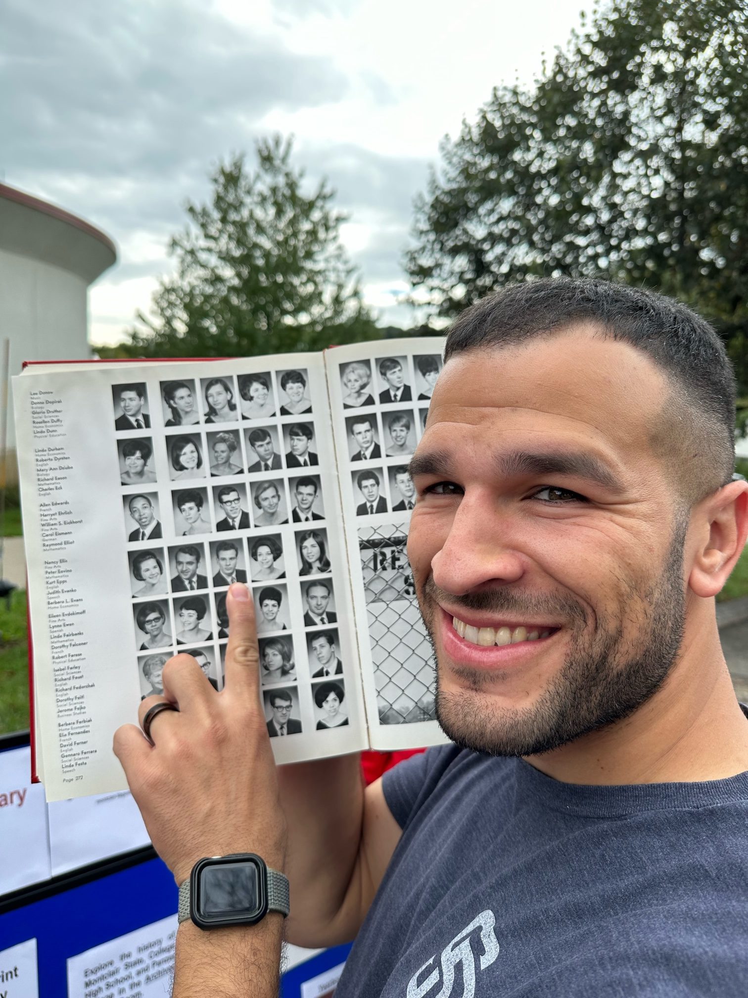 Kacy Epps with yearbook pointing to his dad