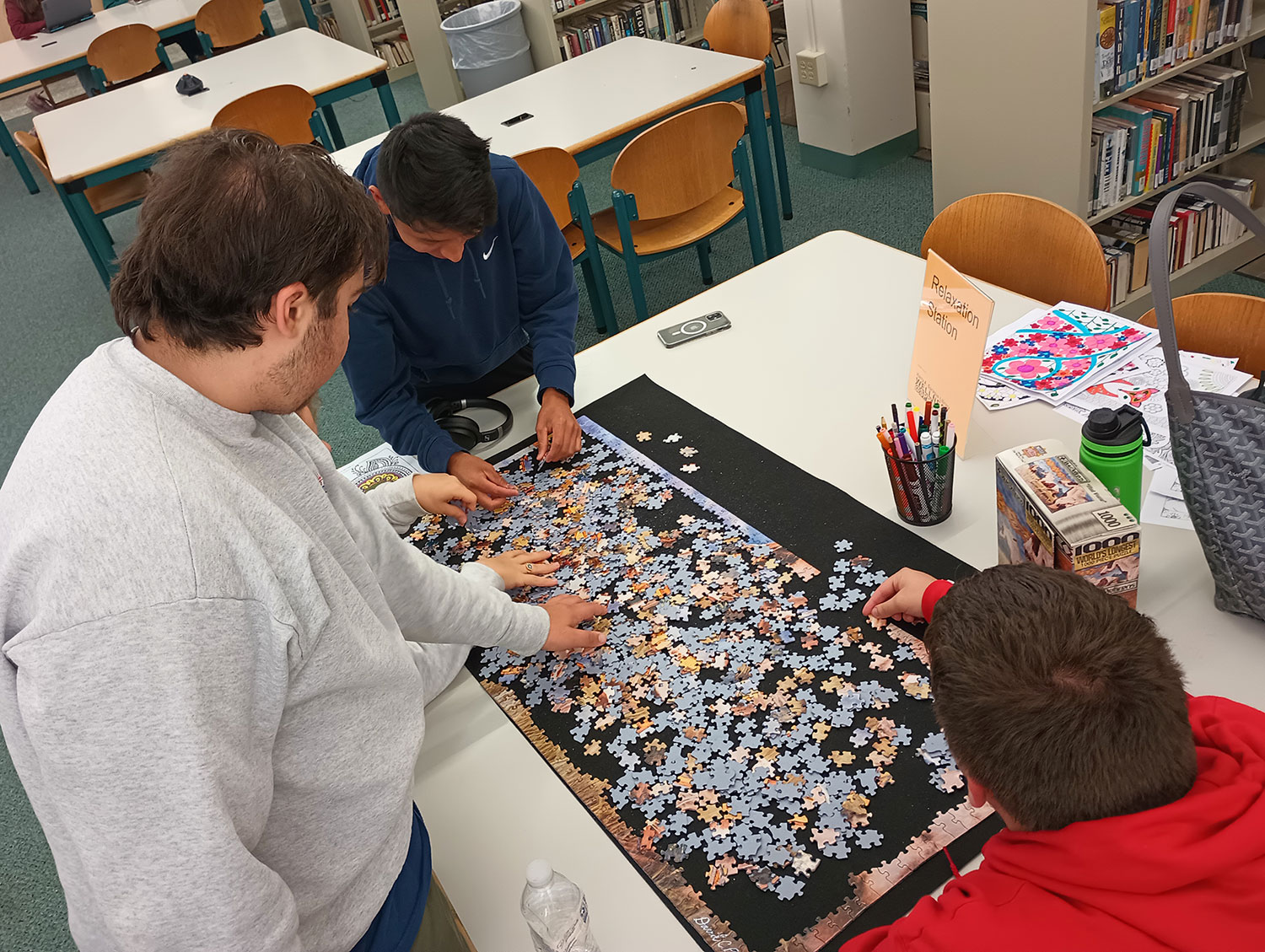 students completing puzzle at library relaxation station