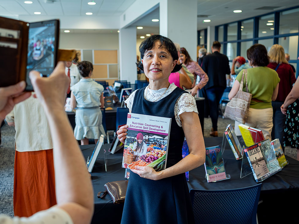 author holding book