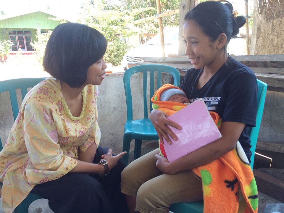 Irma Hidayana in Indonesia helping a new mother.