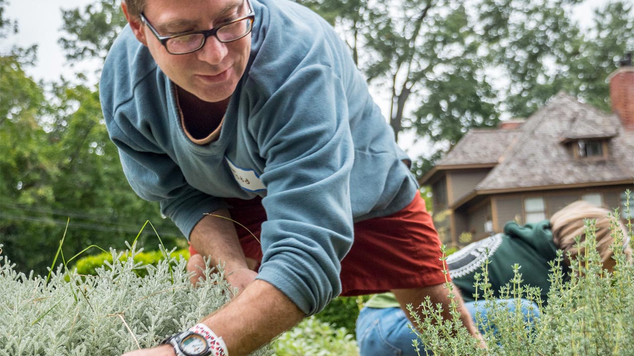 Photo of Professor Todd Kelshaw working at the Montclair Community Farm during the National Day of Service.