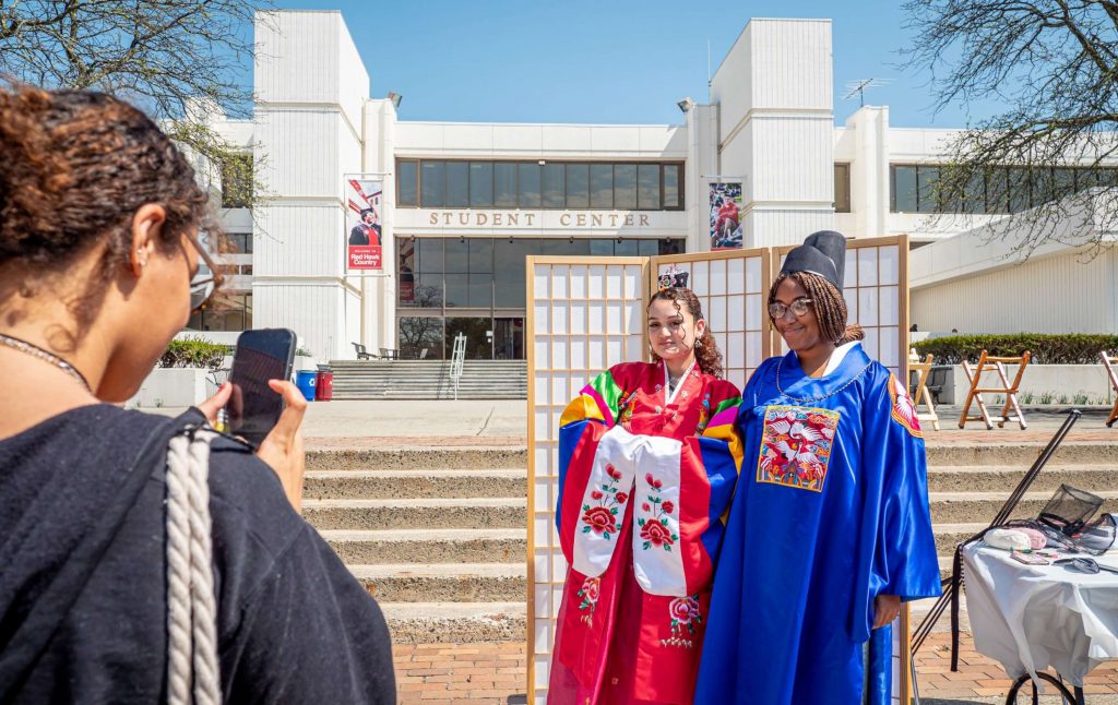 Passerby taking photos of students wearing traditional korean clohing