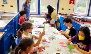 students making Chinese crafts with Montclair State volunteers