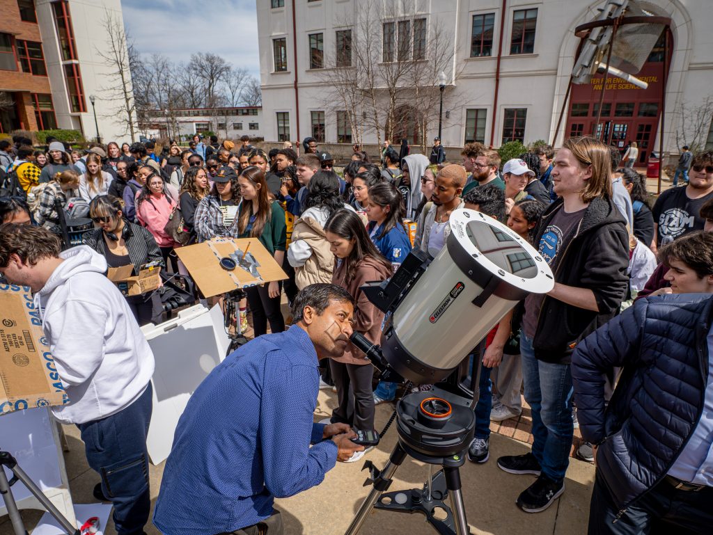 Gathering in front of the Center for Environmental and Life Sciences to view the eclipse. [Photo by John LaRosa.]
