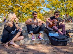 Photo of students playing guitar on main quad
