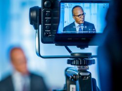 Photo of Lester Holt through camera viewfinder.