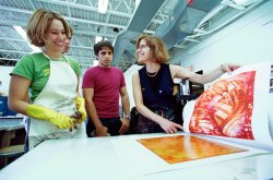 Instructor discussing printmaking with two students
