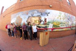 people standing in front of mural