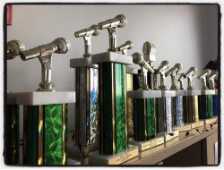 A row of trophies on a shelf for wmsc radio awards