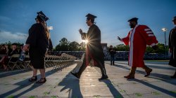 Graduates-casting-long-shadows-walking-for-convocation