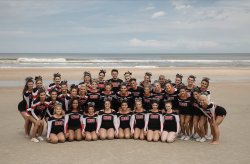 Montclair State University's All Girl and Coed Cheer team posing on the beach