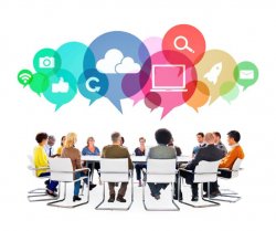 Stock photo of business people around a table with speech bubbles above their heads