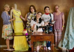 Photo of actresses in spanish language play of Real Women Have Curves. Pictured with dresses and sewing equipment