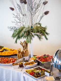 A variety of food displayed prominently on a table at the Conference Center in the Main Ballroom.