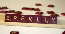 "brevity" spelled out in Scrabble tiles