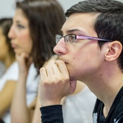 Image of a student listening in class.