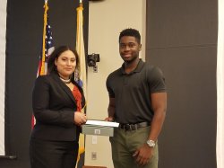 Student presents award to another student