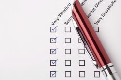 Stock photo of a satisfaction survey with checkboxes and a pen
