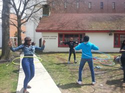 Three students hula hooping outside the Drop In Center