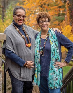 Delores McMorrin and Lorraine Whitaker posing outdoors in fall folliage