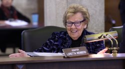 Senator Loretta Weinberg smiling while sitting behind desk.