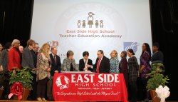 Dr. Susan Cole with other educational leaders on stage at East Side High School
