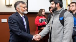 Ambassador of Pakistan to the United Nations, His Excellency Nabeel Munir, shaking hands with a student