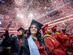 Confetti falling over graduates at Montclair State University's Winter 2024 Commencement