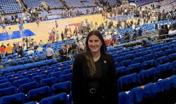Emily Swedelson standing in the stands at Madison Square Garden with the court in the background.