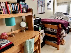 Another side of a double room in Blanton Hall with a bed and desk decorated by a student.