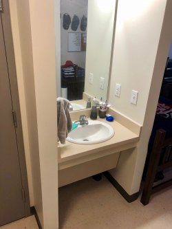 The sink and mirror inside a Double Room in the Heights.