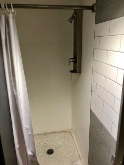 The shower stall in a bathroom in Stone Hall.