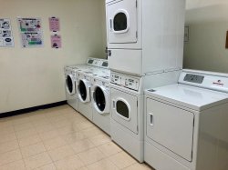 The laundry area in the Village Apartments with washers and driers.