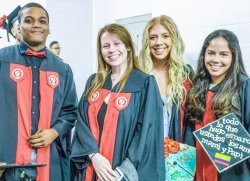 Image of students in cap and gown at a graduation ceremony.