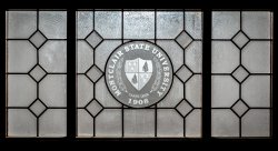 Decorative glass window with the Montclair State Shield on it.